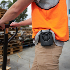 Worker staying cool on job with ArcticFan portable waist fan