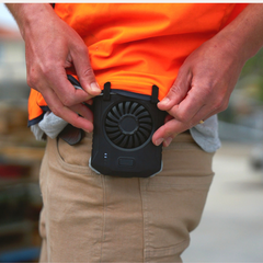 Warehouse worker attaching ArcticFan portable fan to his waist